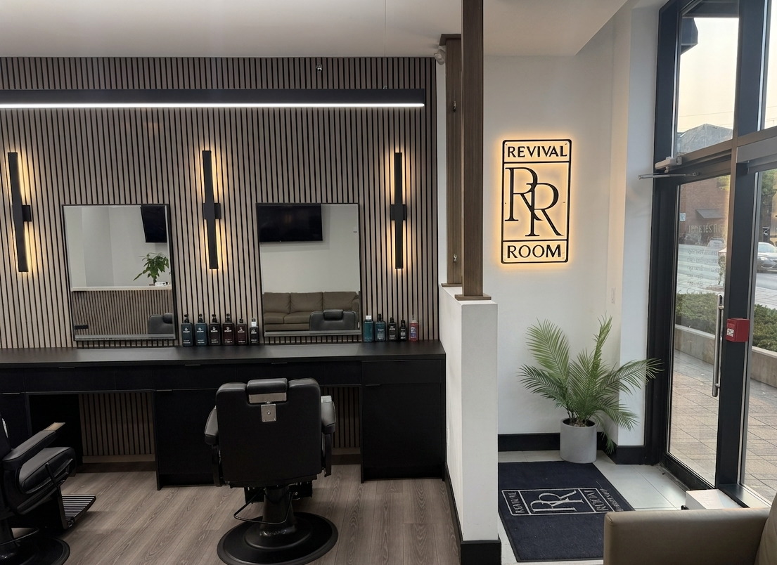 The styling stations and the lit Revival Room sign by the entrance