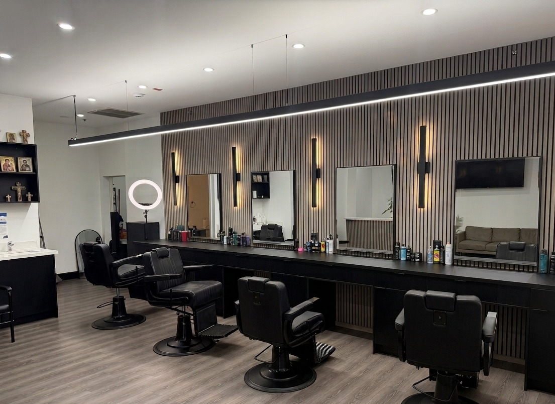 The row of barber chairs along the slatted wood wall