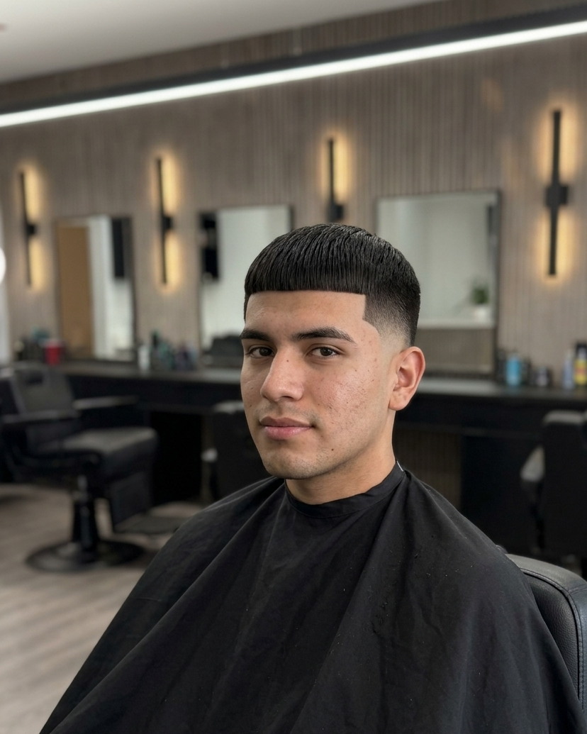 A burst fade with a blunt straight fringe